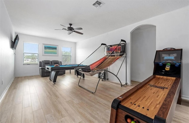 rec room with visible vents, light wood-style floors, arched walkways, billiards, and a ceiling fan