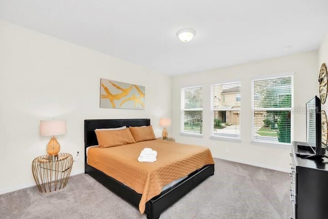 bedroom with carpet flooring and baseboards