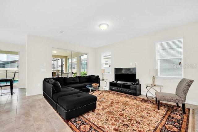 living room featuring light tile patterned floors and baseboards