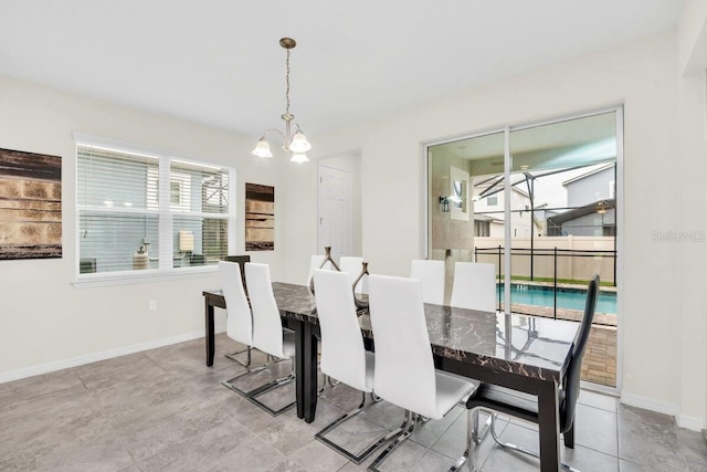 dining space with a chandelier and baseboards