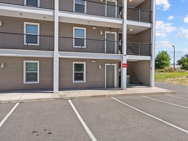 view of building exterior featuring uncovered parking