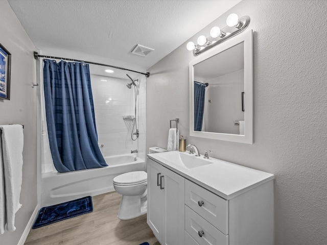 full bath featuring visible vents, toilet, wood finished floors, a textured ceiling, and shower / bathtub combination with curtain