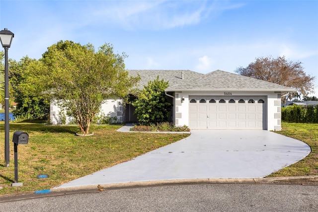 ranch-style house featuring concrete driveway, a front yard, roof with shingles, stucco siding, and a garage