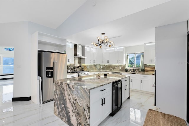 kitchen featuring a notable chandelier, marble finish floor, stainless steel refrigerator with ice dispenser, light stone counters, and wall chimney range hood