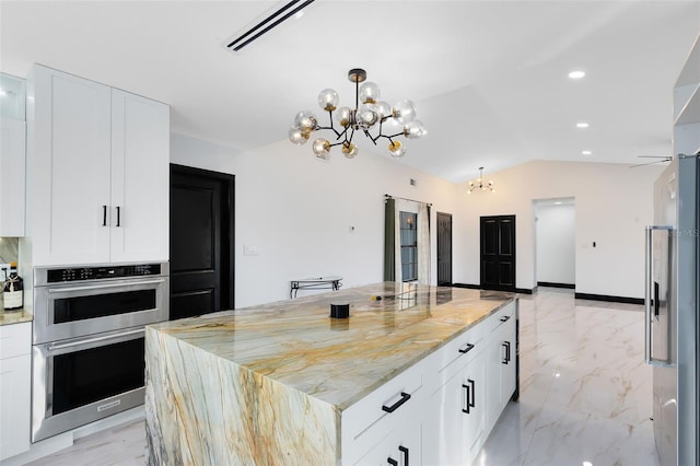 kitchen with visible vents, marble finish floor, appliances with stainless steel finishes, an inviting chandelier, and vaulted ceiling