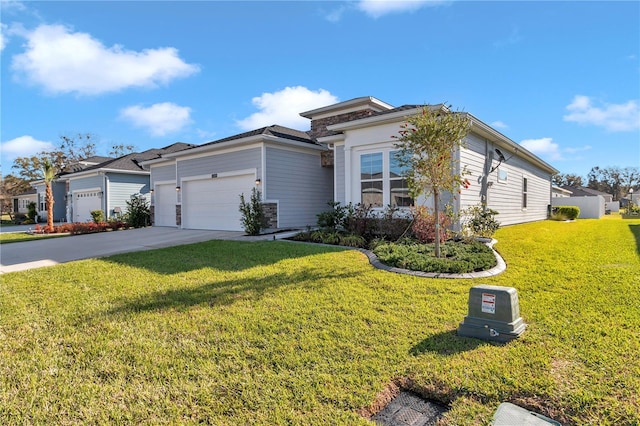 view of front of property featuring an attached garage, driveway, and a front lawn