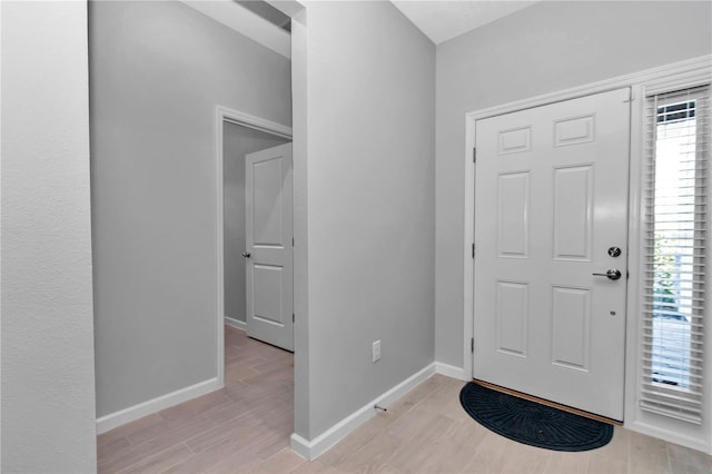 entryway featuring light wood finished floors and baseboards