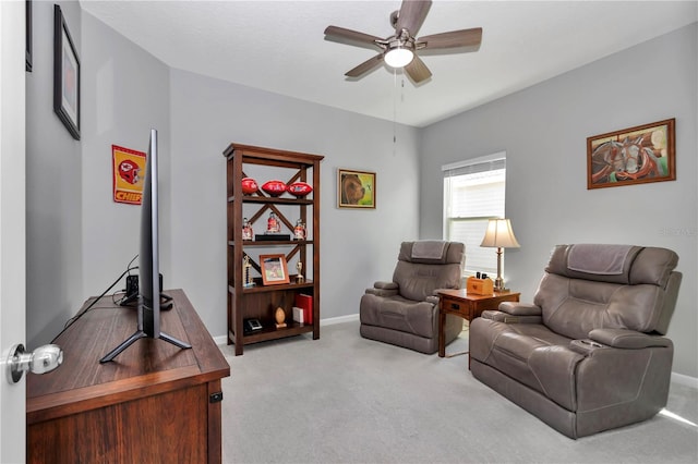 living area featuring baseboards, carpet floors, and a ceiling fan