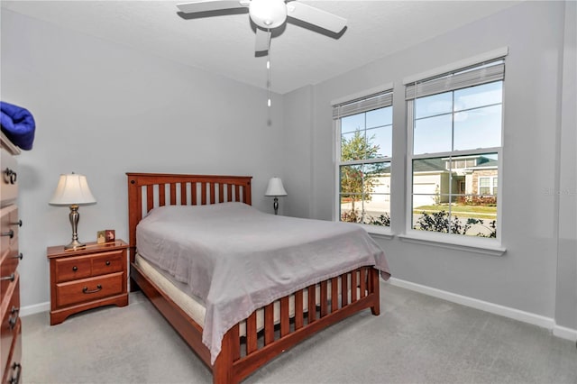 bedroom with baseboards, carpet floors, and a ceiling fan