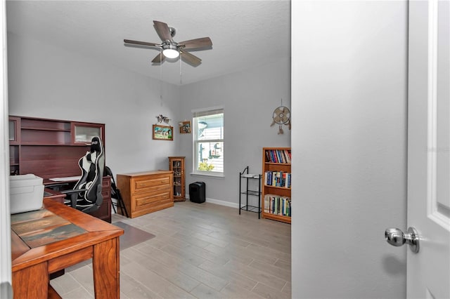 home office featuring light wood-style flooring, baseboards, and ceiling fan