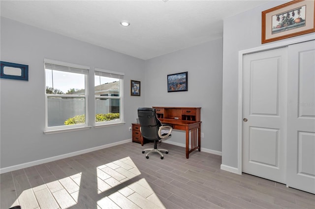 office space with light wood finished floors and baseboards