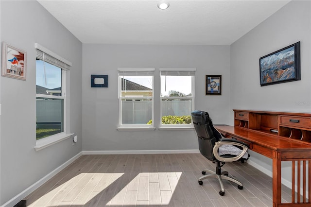 office space with wood finished floors and baseboards