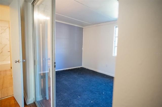 unfurnished room featuring carpet flooring and baseboards