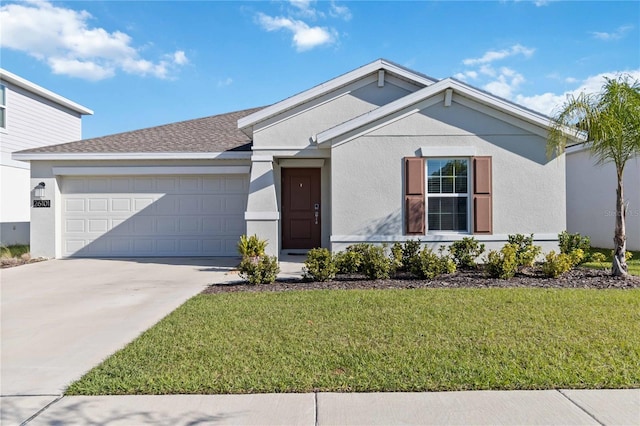 ranch-style house featuring stucco siding, driveway, a front yard, and a garage