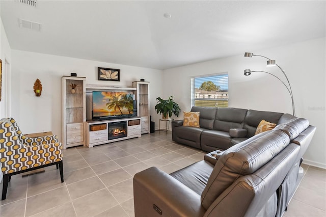 living area featuring light tile patterned flooring and visible vents