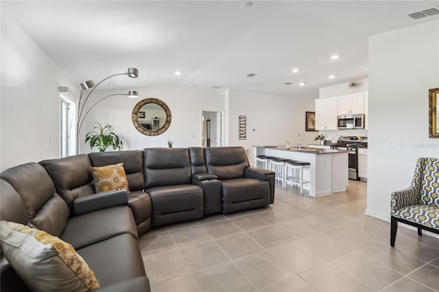 living area featuring recessed lighting, visible vents, lofted ceiling, and light tile patterned flooring