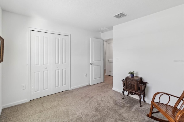 bedroom featuring carpet flooring, baseboards, visible vents, and a closet