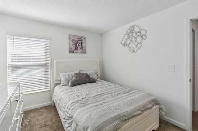 bedroom featuring carpet flooring and baseboards