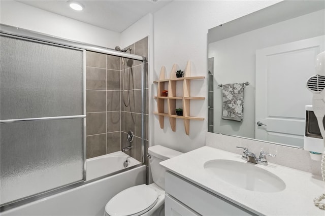 full bathroom with vanity, toilet, and bath / shower combo with glass door