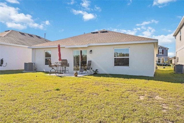 back of house with stucco siding, a yard, central AC unit, and a patio area