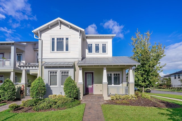 13852 Maskawa Ave, Orlando, FL 32827 - view of front of home with covered porch, metal roof, a standing seam roof, and stucco siding