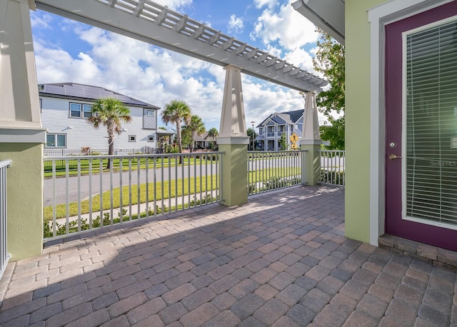 view of patio / terrace featuring a residential view, a pergola, and fence