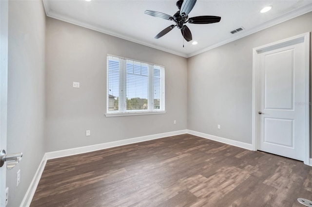 empty room with visible vents, baseboards, dark wood-style floors, and ornamental molding