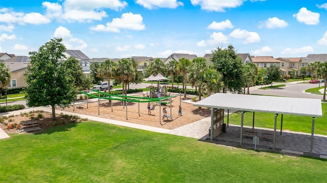 surrounding community with playground community, a yard, and a residential view