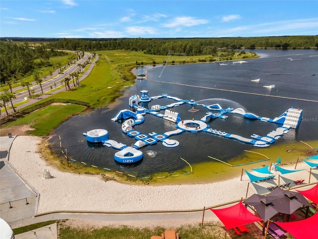 aerial view with a wooded view and a water view