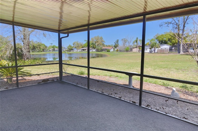 unfurnished sunroom with a water view