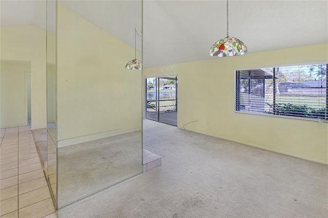 unfurnished dining area with baseboards, carpet floors, and high vaulted ceiling