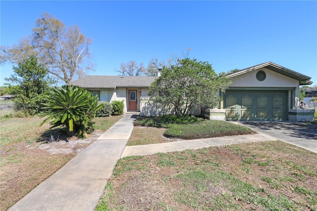 view of front of home featuring stucco siding, an attached garage, and concrete driveway