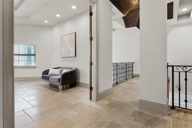 hall with visible vents, stone tile floors, recessed lighting, and baseboards