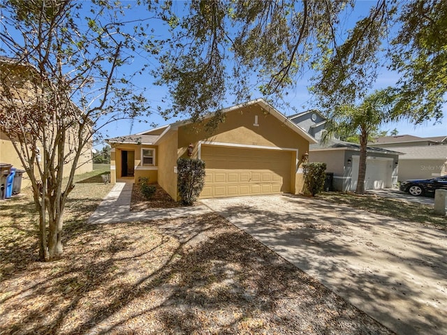 ranch-style home with stucco siding, concrete driveway, and a garage