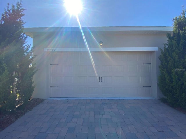 garage with decorative driveway