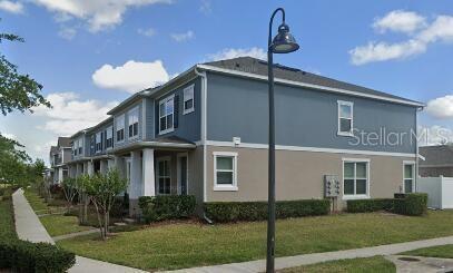 view of side of property with stucco siding and a yard