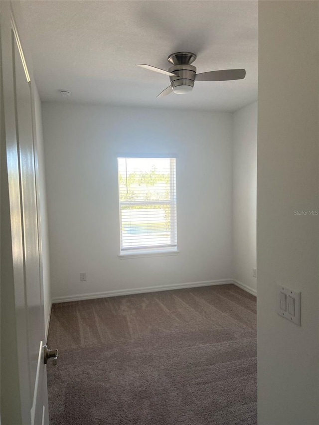 spare room with a ceiling fan, baseboards, carpet floors, and a textured ceiling