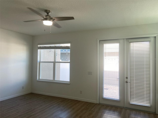 unfurnished room with a textured ceiling, wood finished floors, french doors, baseboards, and ceiling fan