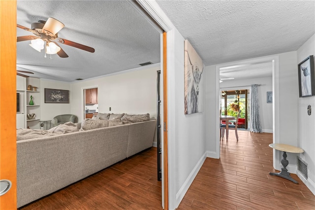 interior space with ceiling fan, visible vents, and wood finished floors