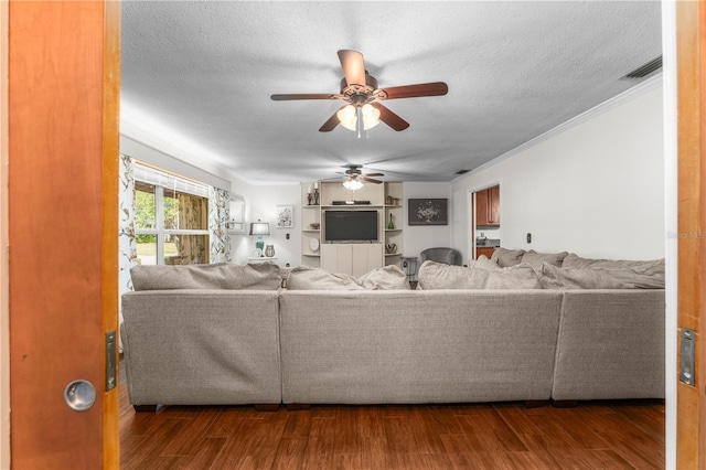 living area featuring ceiling fan, visible vents, a textured ceiling, and wood finished floors