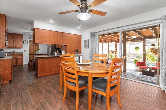 dining space featuring dark wood finished floors and ceiling fan