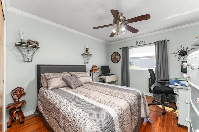 bedroom with a ceiling fan, crown molding, wood finished floors, and baseboards