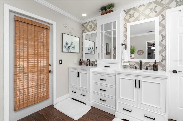 full bath featuring a sink, wood finish floors, double vanity, and crown molding