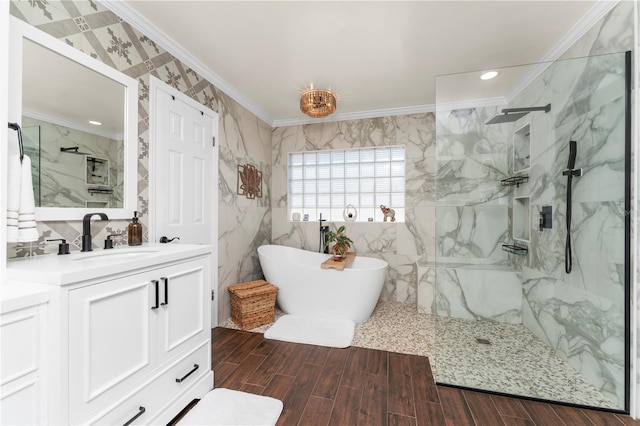 full bathroom featuring wood finish floors, a freestanding tub, a marble finish shower, crown molding, and vanity