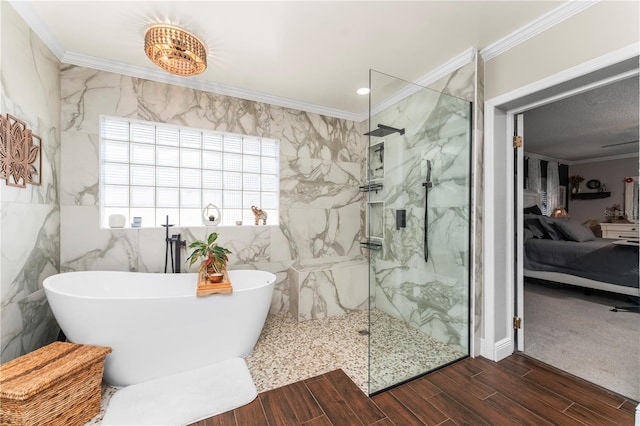 ensuite bathroom featuring a marble finish shower, wood finish floors, ornamental molding, a soaking tub, and ensuite bath