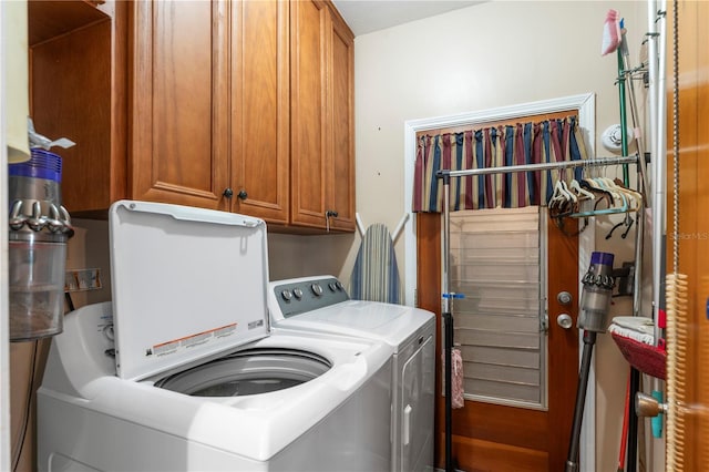 laundry room featuring cabinet space and washer and clothes dryer