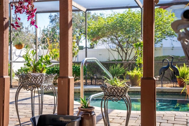 pool with a lanai, a patio area, and fence