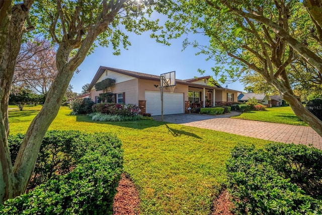 single story home featuring driveway, a front lawn, and an attached garage