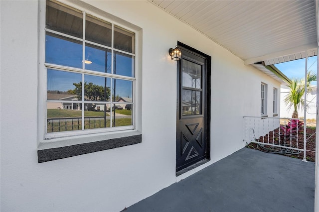 entrance to property featuring stucco siding