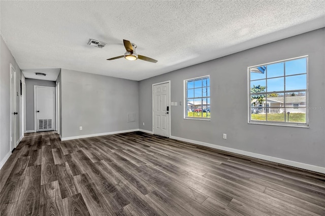 interior space with visible vents, baseboards, and dark wood-type flooring